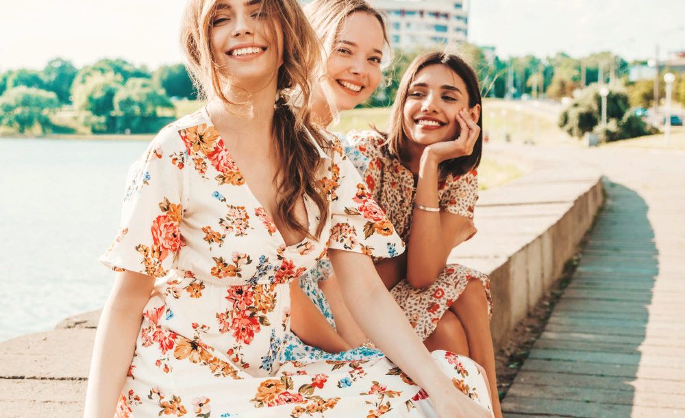 three-beautiful-smiling-girls-trendy-summer-sundress-posing-street